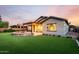 A backyard oasis with artificial grass, a custom firepit, covered patio, and professional landscaping at 21022 E Arroyo Verde Ct, Queen Creek, AZ 85142