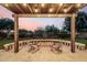 Outdoor patio area with string lights, desert landscaping, and comfortable seating at 21022 E Arroyo Verde Ct, Queen Creek, AZ 85142