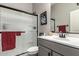 Well-lit bathroom with a glass-enclosed shower, gray vanity, and modern sink faucet at 21022 E Arroyo Verde Ct, Queen Creek, AZ 85142