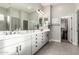 Bright bathroom features a double sink vanity, large mirror, and walk-in closet for ample storage at 21022 E Arroyo Verde Ct, Queen Creek, AZ 85142