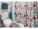 Bathroom features a toilet and decorative shower curtain, adding a touch of color and style at 21022 E Arroyo Verde Ct, Queen Creek, AZ 85142