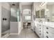 The bathroom has a tiled walk-in shower, a separate vanity with a dual sink, and modern fixtures at 21022 E Arroyo Verde Ct, Queen Creek, AZ 85142