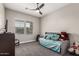 Relaxing bedroom with a trundle bed, ceiling fan, and bright window, perfect for guests at 21022 E Arroyo Verde Ct, Queen Creek, AZ 85142
