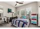 Serene bedroom featuring a ceiling fan, bright window, and a desk area at 21022 E Arroyo Verde Ct, Queen Creek, AZ 85142
