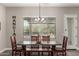 Dining room with a modern table and chairs set near a large window at 21022 E Arroyo Verde Ct, Queen Creek, AZ 85142