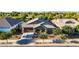 Charming single-story home featuring a well-manicured front yard and a covered porch with seating area at 21022 E Arroyo Verde Ct, Queen Creek, AZ 85142