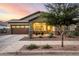 Charming single-story home with a two-car garage, inviting front porch, and desert landscaping at 21022 E Arroyo Verde Ct, Queen Creek, AZ 85142