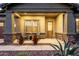 Inviting front porch with seating, decorative plants, and a stylish front door at 21022 E Arroyo Verde Ct, Queen Creek, AZ 85142