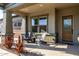 Inviting front porch with seating, decorative plants, and a stylish front door at 21022 E Arroyo Verde Ct, Queen Creek, AZ 85142