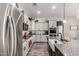 Features a spacious kitchen, large granite island with sink, stainless steel appliances, and white cabinets at 21022 E Arroyo Verde Ct, Queen Creek, AZ 85142