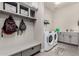 Functional laundry room with built-in storage, modern washer/dryer and gray accents at 21022 E Arroyo Verde Ct, Queen Creek, AZ 85142