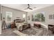 Bedroom with hardwood floors, a ceiling fan, and large windows that provide ample natural light at 21022 E Arroyo Verde Ct, Queen Creek, AZ 85142