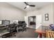 Spacious home office with two workstations, natural light, and view into a comfortable living room at 21022 E Arroyo Verde Ct, Queen Creek, AZ 85142