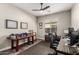 Bright home office with ceiling fan, two desks, and interesting decorations that add character at 21022 E Arroyo Verde Ct, Queen Creek, AZ 85142