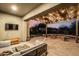 Inviting outdoor patio area with string lights, comfortable seating, and landscaped backyard at 21022 E Arroyo Verde Ct, Queen Creek, AZ 85142
