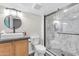 Bathroom featuring a glass-enclosed shower with marble tile surround and stylish vanity at 23886 W Harrison Dr, Buckeye, AZ 85326