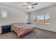 Comfortable bedroom featuring a ceiling fan and a large window for natural light at 23886 W Harrison Dr, Buckeye, AZ 85326