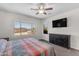 Bright bedroom with a large window, ceiling fan, and a view of the backyard at 23886 W Harrison Dr, Buckeye, AZ 85326