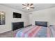 This bedroom has a bed, two dressers, and a ceiling fan at 23886 W Harrison Dr, Buckeye, AZ 85326