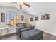 Bonus room featuring a cozy seating area and fun gaming-themed decor at 23886 W Harrison Dr, Buckeye, AZ 85326