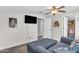 Bonus room with comfortable seating, a mounted TV, and neutral wall color at 23886 W Harrison Dr, Buckeye, AZ 85326