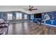 Entertainment room featuring a large television, ceiling fan, and sports memorabilia at 23886 W Harrison Dr, Buckeye, AZ 85326