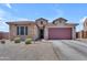 Charming single-Gathering home featuring stone accents, a spacious two-car garage, and low-maintenance desert landscaping at 23886 W Harrison Dr, Buckeye, AZ 85326