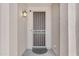 Close-up of a secure front entry featuring a storm door and stylish wall-mounted lighting at 23886 W Harrison Dr, Buckeye, AZ 85326