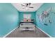 Bright home office featuring a modern desk, world map accent wall, and neutral carpet at 23886 W Harrison Dr, Buckeye, AZ 85326