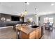 Stylish kitchen island with seating, pendant lighting, and easy access to the living and dining areas at 23886 W Harrison Dr, Buckeye, AZ 85326