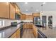 This kitchen features wooden cabinets, granite countertops, a sink, and stainless steel appliances at 23886 W Harrison Dr, Buckeye, AZ 85326