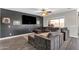 Cozy living room featuring a large sectional couch, ceiling fan, and access to the backyard at 23886 W Harrison Dr, Buckeye, AZ 85326