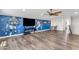 Large living room featuring sports decor, an entertainment area and a nearby dining set at 23886 W Harrison Dr, Buckeye, AZ 85326