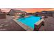 Private backyard featuring a refreshing swimming pool, fire pit, and comfortable patio seating at 23886 W Harrison Dr, Buckeye, AZ 85326
