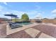 Backyard with a private pool, patio furniture, and lush desert landscaping at 23886 W Harrison Dr, Buckeye, AZ 85326
