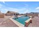 Resort-style pool and patio with dining, lounge seating, and well-manicured landscaping at 23886 W Harrison Dr, Buckeye, AZ 85326