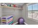 Walk-in closet with built-in shelving and a view of the backyard pool area at 23886 W Harrison Dr, Buckeye, AZ 85326