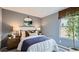 Beautifully designed bedroom with cool gray walls, a large window, and stylish modern decor at 25038 N 174Th Ln, Surprise, AZ 85387