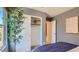 Cozy bedroom with modern gray walls, white trim and door, and view to the outside at 25038 N 174Th Ln, Surprise, AZ 85387