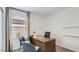 Bright and functional home office space with a large desk, comfortable seating, and plenty of natural light at 25038 N 174Th Ln, Surprise, AZ 85387