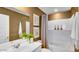 Bright bathroom with a white sink vanity, framed mirror and framed artwork on the wall at 25082 N 174Th Ln, Surprise, AZ 85387