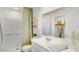 Clean bathroom with white subway tile shower, decorative shelf, and light green accents, creating a relaxing space at 25082 N 174Th Ln, Surprise, AZ 85387