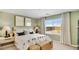 Cozy bedroom with natural light, a comfortable bed, and neutral decor, creating a serene atmosphere at 25082 N 174Th Ln, Surprise, AZ 85387