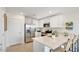 Well-lit kitchen with white cabinets, stainless steel appliances, and a spacious center island with seating at 25082 N 174Th Ln, Surprise, AZ 85387