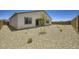 Backyard featuring minimalist landscaping with rocks, young trees, and desert plants at 25162 N 177Th Dr, Surprise, AZ 85387