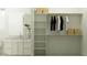 Spacious walk-in closet and bathroom featuring a modern sink, shelving and hanging rods at 25162 N 177Th Dr, Surprise, AZ 85387
