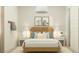 Inviting bedroom with a wood bed frame, white linens, and tasteful black and white wall art at 25162 N 177Th Dr, Surprise, AZ 85387