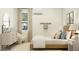 Cozy bedroom with a wood bed frame, a white accent chair, and a serene atmosphere at 25162 N 177Th Dr, Surprise, AZ 85387