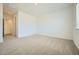 Spacious bedroom showcasing neutral carpet, a window for natural light, and ample room for furniture at 25162 N 177Th Dr, Surprise, AZ 85387