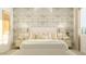 Bright bedroom with decorative wallpaper, bedside lamps, and a comfortable queen-sized bed at 25162 N 177Th Dr, Surprise, AZ 85387